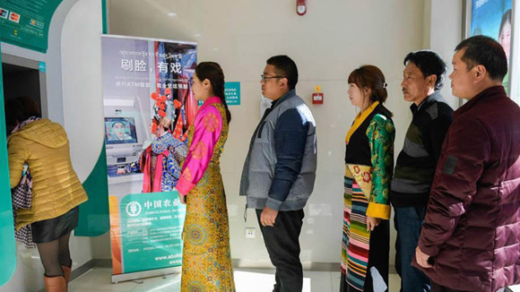 The People wait in line to withdraw cash from an ATM at a branch of the Agricultural Bank of China (ABC) in southwest China's Tibet Autonomous Region. (Photo provided to CGTN)