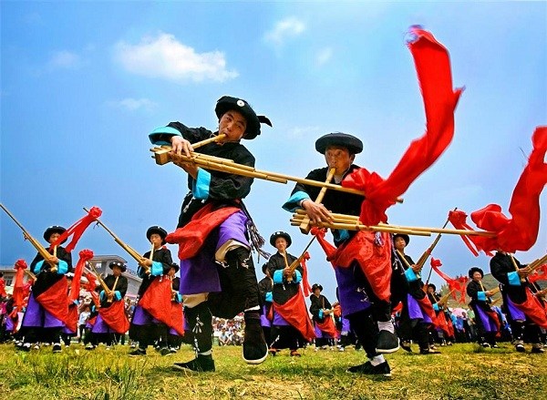Young men play the lusheng, a reed musical instrument, during the Lusheng Festival, one of the most significent fests of the Miao people. (Ti Gong)