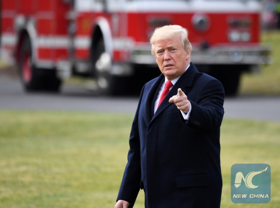 File Photo: U.S. President Donald Trump gestures as he leaves the White House en route to Mar-a-lago Estate in Florida after signing the tax cut bill into law in Washington D.C., the United States, on Dec. 22, 2017. (Xinhua/Yin Bogu)