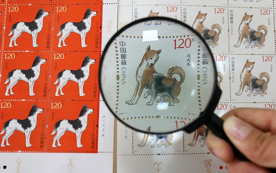 Collector's stamps for the Year of the Dog on display at a post office in Weifang, Shandong province, on Wednesday. (Zhang Chi/For China Daily)
