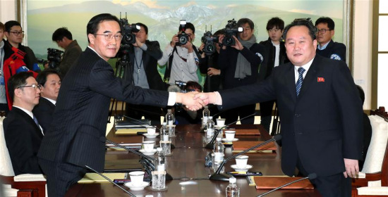 Ri Son-gwon (R), chairman of the Committee for the Peaceful Reunification of the Fatherland of the Democratic People's Republic of Korea (DPRK), shakes hands with South Korean Unification Minister Cho Myoung-gyon in the truce village of Panmunjom, Jan. 9, 2018. South Korea and the DPRK on Tuesday kicked off a senior-level, inter-governmental dialogue in the truce village of Panmunjom. (Xinhua/Newsis)