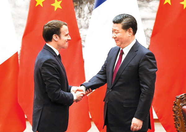 President Xi Jinping shakes hands with French President Emmanuel Macron after meeting the press at the Great Hall of the People on Tuesday in Beijing. (Photo:China Daily/Feng Yongbin)