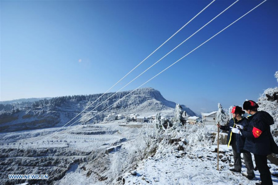 Staff members of Wuchuan Power Supply Bureau check supply lines in Wuchuan Gelao and Miao Autonomous County, southwest China's Guizhou Province, Jan. 9, 2018. (Xinhua/Tao Liang)