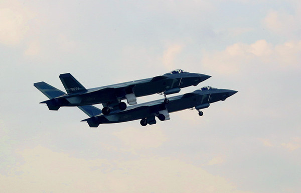 Two J-20 fighter jets conduct an exercise. (LI SHAOPENG/XINHUA)