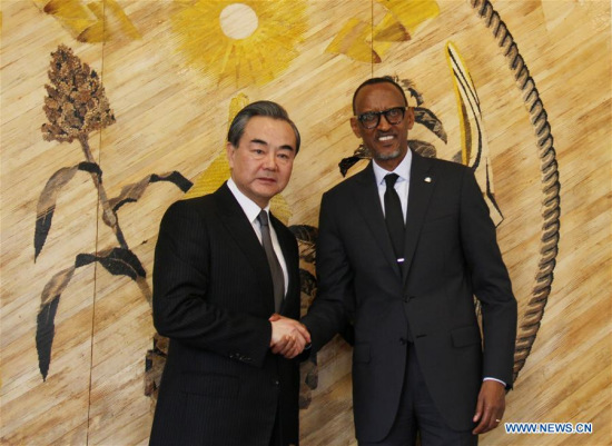 Chinese Foreign Minister Wang Yi (L) shakes hands with Rwandan President Paul Kagame during their meeting in Kigali, capital of Rwanda, on Jan. 13, 2018. (Xinhua/Lyu Tianran)