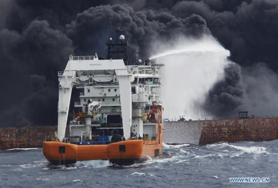 Rescuers spray foam to extinguish flames on the stricken oil tanker SANCHI off the coast of east China's Shanghai, Jan. 12, 2018. (Xinhua)