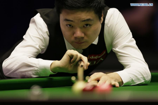 Ding Junhui of China hits the ball during the first round match with Ryan Day of Wales at Snooker Masters 2018 at the Alexandra Palace in London, Britain on Jan. 15, 2018. Ryan Day won 6-4. (Xinhua/Tim Ireland)