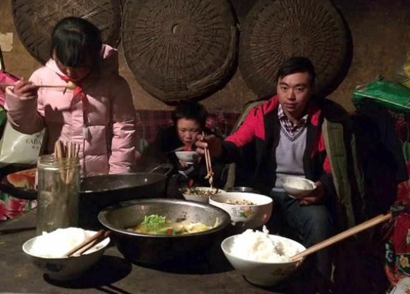 Wang Fuman, dubbed Snowflake Boy by netizens, shares a meal with his family on Thursday. (Photo by ZHANG YUJIE/FOR CHINA DAILY)