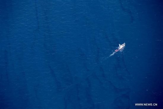 Aerial photo taken aboard surveillance plane of the State Oceanic Administration (SOA) shows the oil spill on the water surface around the sunken Iranian tanker Sanchi in the East China Sea, Jan. 15, 2018. (Xinhua/Liu Shiping)
