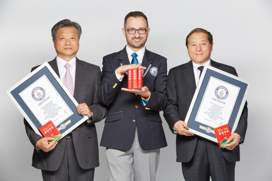 Guinness World Records SVP of Records Management and General Manager of China Office Marco Frigatti(M) presents the certificates to Xinhua Dictionary. (Photo by Guinness World Records)