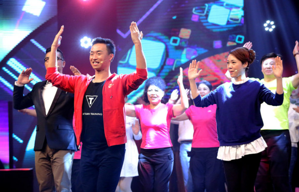 Wang Guangcheng, nicknamed China's Square Dancing Prince, leads a dance troupe in a televised entertainment show. Photo by KANG ZHENG/FOR CHINA DAILY