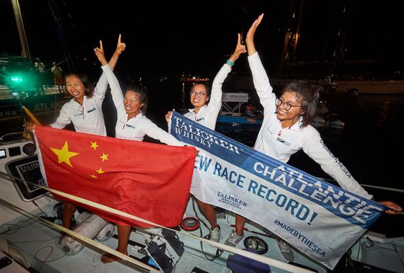 The Kung Fu Cha-Cha rowing squad from Shantou University celebrate their success on Wednesday night in Antigua and Barbuda. They completed a trans-Atlantic voyage in 34 days. PROVIDED TO CHINA DAILY