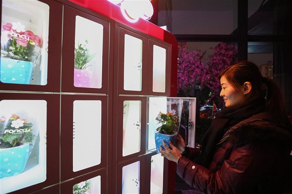 A Fancy staff member adjusts a display of flowering plants ahead of the trial run. (Jiang Xiaowei/SHINE)