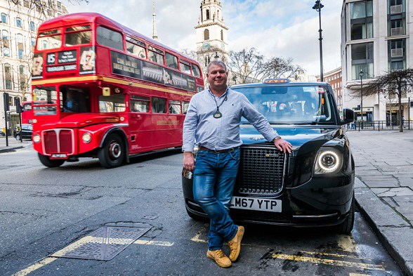 London cabbie David Harris says the TX electric taxi will save him hundreds of pounds a month. (Photo for China Daily)