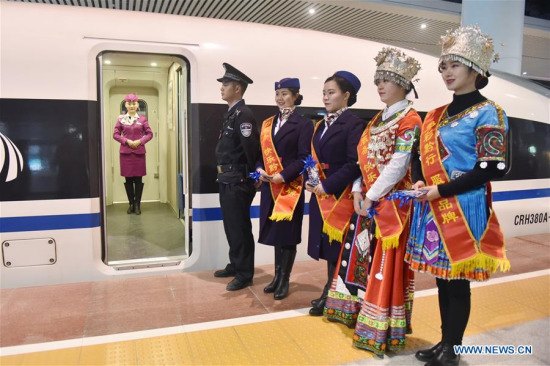 Crew members wait for passengers to board the train at Guiyang North Railway Station in Guiyang, southwest China's Guizhou Province, Jan. 25, 2018. (Xinhua/Ou Dongqu)