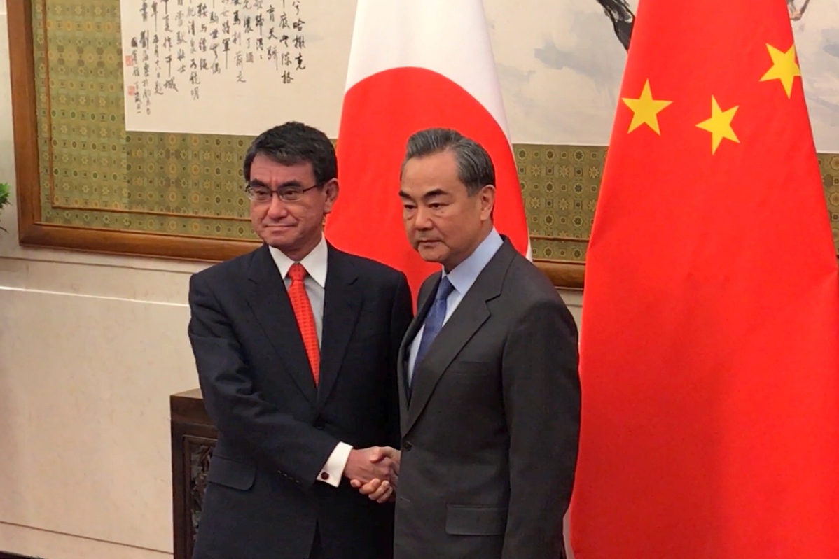 Foreign Minister Wang Yi meets with his visiting Japanese counterpart Taro Kono at Diaoyutai State Guesthouse Sunday morning in Beijing. (Zhang Yunbi/For chinadaily.com.cn)