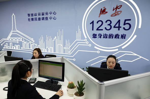 As part of a modernization drive in Yan'an, Shaanxi province, operators answer calls from the public at the office of smart government service platform 12345 in January. (Zhu Xingxin/China Daily)