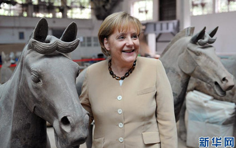 German Chancellor Angela Merkel poses for a photo between two horse statues at the Terracotta Army site in Xi'an, China, in July 2010. Merkel, who celebrated her 56th birthday in Xi'an, was born in the Year of the Horse according to the Chinese zodiac. The German chancellor was on a five-day visit to Russia, China and Kazakhstan. (Photo/Xinhua)
