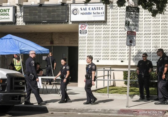 Police officers stand guard outside Salvador Castro Middle School in Los Angeles, the United States, Feb. 1, 2018. Five people were injured, including two students shot, in a classroom shooting Thursday at the Salvador Castro Middle School in the western U.S. city of Los Angeles, local authorities said. (Xinhua/Zhao Hanrong)
