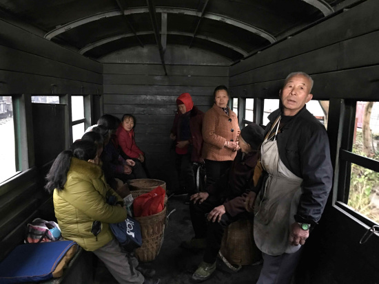 Local farmers living alongside the railway take the small train to the fair in town. /CGTN Photo