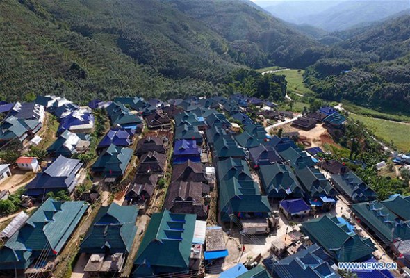 Photo taken on Sep 15, 2017 shows the bird's-eye view of Mannashan Village in Bulangshan Town of Menghai County, Southwest China's Yunnan province. A total of 524 people of the Bulang ethnic group live at the village and most of them have built new houses with the help of government under a policy of poverty alleviation. (Photo/Xinhua)