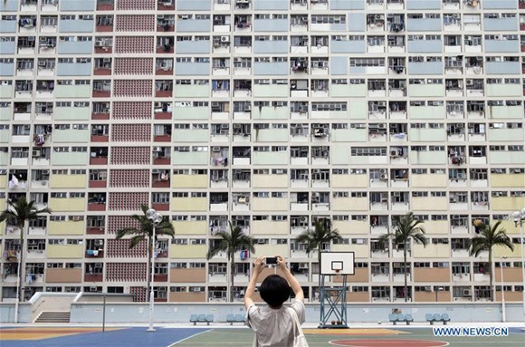 A tourist takes photos of Choi Hung Estate in Hong Kong, south China, May 17, 2017. (Xinhua/Liu Yun)