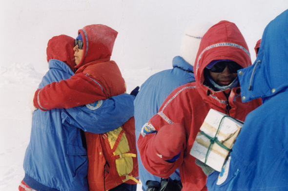 Members of the team embrace each other after they reach the North Pole. (Photo provided to China Daily)