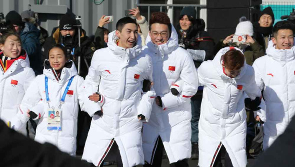 Chinese athletes and coaches dance to Korean pop music following a flag-raising ceremony ahead of the 2018 Winter Olympics in Pyeongchang on Wednesday. FENG YONGBIN/CHINA DAILY