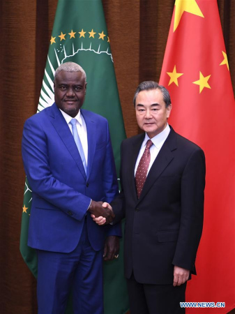 Chinese Foreign Minister Wang Yi (R) shakes hands with Chairperson of theAfrican Union(AU) Commission Moussa Faki Mahamat at the 7th China-AU strategic dialogue in Beijing, capital of China, Feb. 8, 2018. (Xinhua/Yan Yan)