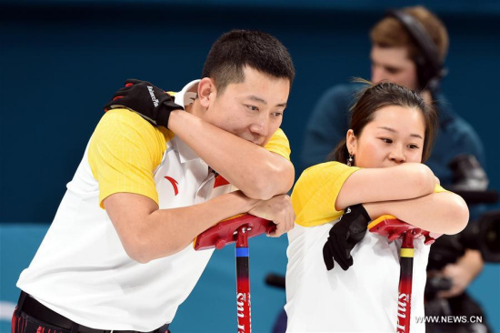 China's Wang Rui (R) and Ba Dexin react during the mixed doubles round robin session 2 of curling event between China and South Korea at the 2018 PyeongChang Winter Olympic Games, South Korea, Feb. 8, 2018. China won 8-7. (Xinhua/Ma Ping)