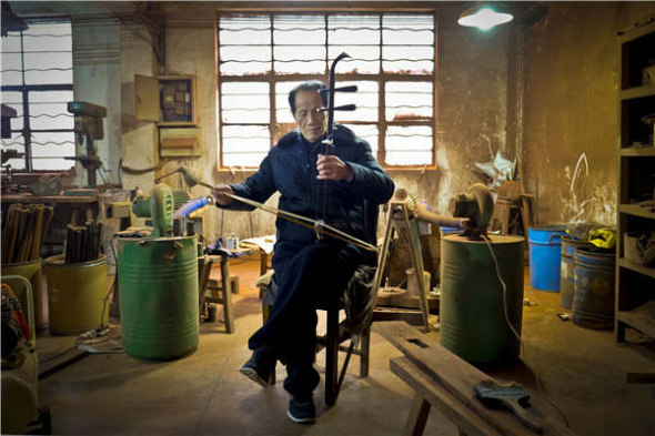 Gu Yue, a well-known company in Wuxi that produces erhu, is home to dozens of middle-aged artisans who painstakingly assemble each erhu by hand. (Photo by Alywin Chew/China Daily)