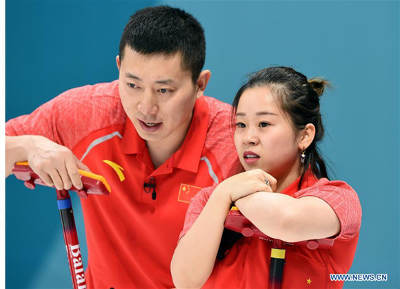 China's Ba Dexin (L) and Wang Rui react during the curling mixed doubles round robin session 5 against Becca Hamilton and Matt Hamilton from the United States at the 2018 PyeongChang Winter Olympic Games at the Gangneung Curling Centre in Gangneung, South Korea, on Feb. 10, 2018.  (Xinhua/Ma Ping)