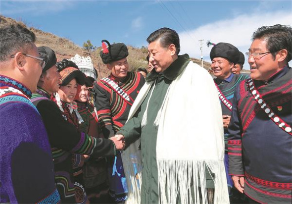 General Secretary Xi Jinping greets local residents in Sanhe, a village in Zhaojue county, Sichuan province, on Sunday. (Ju Peng/Xinhua)