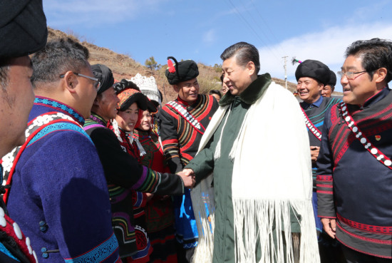 General Secretary Xi Jinping greets local residents in Sanhe, a village in Zhaojue county, Sichuan province, on Sunday. (Photo/Xinhua