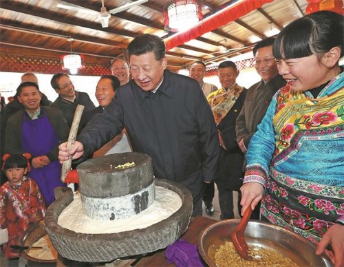 President Xi Jinping, tries cooking fried pork at a restaurant in Yingxiu, Wenchuan county, Sichuan province on Monday. Xi said illiteracy and other obstacles will be thwarted by education and cleanliness. Ju Peng/Xinhua