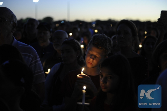People hold candles during a vigil for the victims of the shooting at Marjory Stoneman Douglas High School, in Parkland, Florida, the United States, Feb. 15, 2018. (Xinhua/Liu Yang)