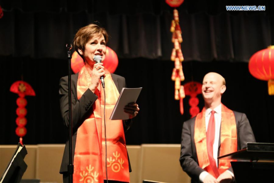 Iowa governor Kim Reynolds (L) wishes audience a Happy Lunar New Year in Muscatine, Iowa of the United States, on Feb. 21, 2018. A Lunar New Year concert featuring rewritten traditional Chinese opera and folk music was held in the small mid-west town of Muscatine, Iowa, on Wednesday night. (Xinhua/Wang Qiang) 