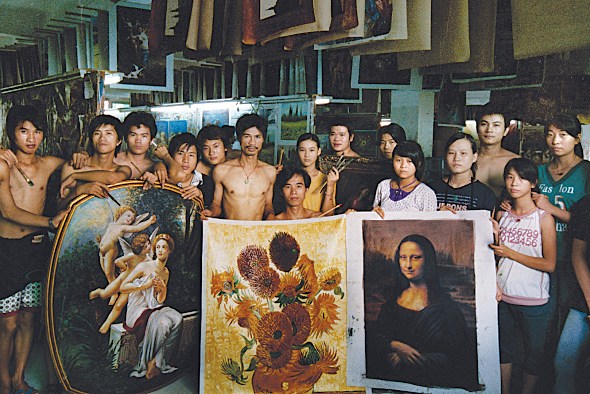 Group of Dafen oil painters holding replica paintings. (Photo by Yu Haibo/ for China Daily)