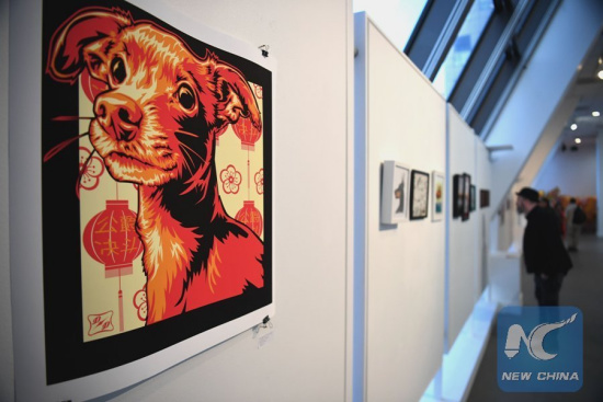 People visit an exhibition at Chinese Culture Center of San Francisco in San Francisco, the United States, on Feb. 22, 2018. Chinese Culture Center of San Francisco celebrated Chinese New Year of the Dog with a dog-themed artwork exhibition. (Xinhua/Wu Xiaoling)