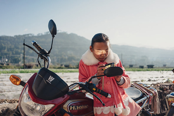 A student checks her camera. Photo by Liu Yuyang/For China Daily