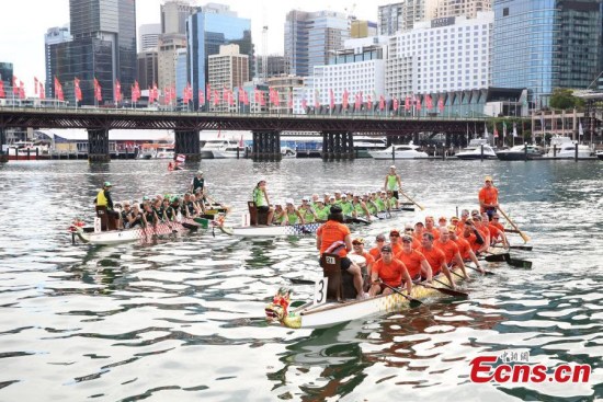 Paddlers compete in the dragon boat race at Cockle Bay wharf in Darling Harbour, Sydney, Australia, Feb. 24, 2018. 