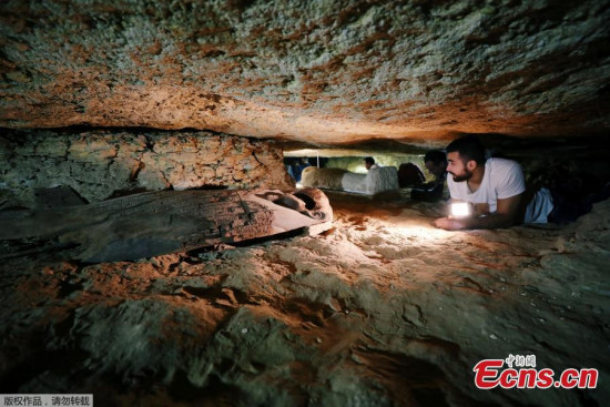An Egyptian antiquities worker is seen inside the recently discovered burial site in Minya, Egypt, Feb. 24, 2018. (Photo/Agencies)