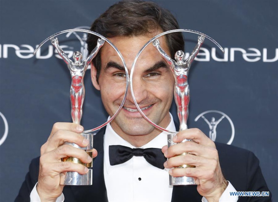 Swiss tennis player Roger Federer poses with the 