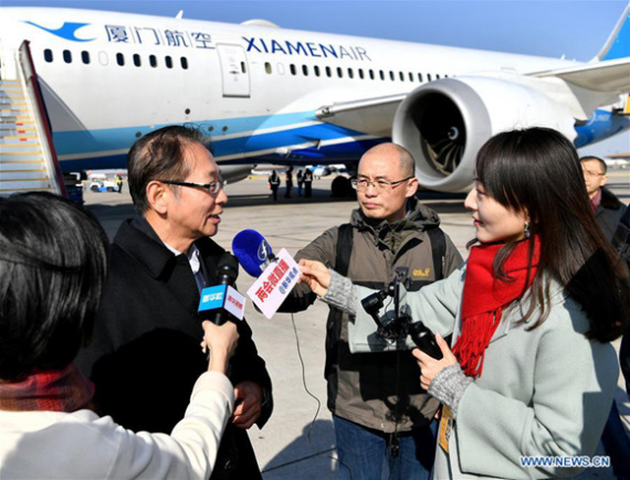 Zheng Lansun (2nd L), member of the 13th National Committee of the Chinese People's Political Consultative Conference (CPPCC) from southeast China's Fujian Province, receives an interview at the Beijing Capital International Airport as he arrives in Beijing, capital of China, March 1, 2018, for the First Session of the 13th CPPCC National Committee. (Xinhua/Li Xin)