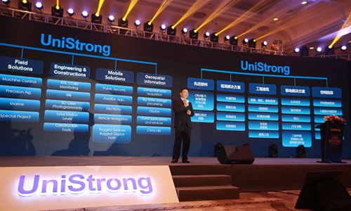 The founder and CEO of the Shenzhen-listed Beijing UniStrong Science & Technology Co delivers a speech at the company's annual global partners summit on Wednesday. (Photo: Deng Xiaoci/GT)