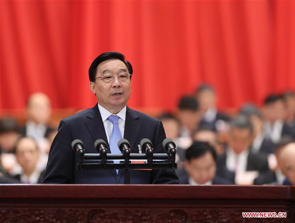 Wang Chen, vice chairperson of the Standing Committee of the 12th National People's Congress (NPC), briefs deputies to the 13th NPC on the draft amendment to China's Constitution at the opening meeting of the first session of the 13th NPC at the Great Hall of the People in Beijing, capital of China, March 5, 2018. (Xinhua/Liu Weibing)