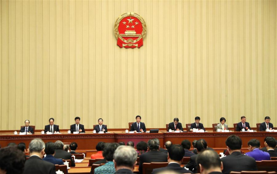 Li Zhanshu, executive chairperson of the presidium of the first session of the 13th National People's Congress (NPC), presides over the second meeting of the presidium at the Great Hall of the People in Beijing, capital of China, March 8, 2018. (Xinhua/Ju Peng)