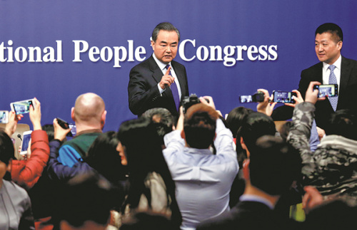 Foreign Minister Wang Yi takes questions from reporters on Thursday at a news conference on the sidelines of the annual session of the National People's Congress in Beijing. (Photo/China Daily)
