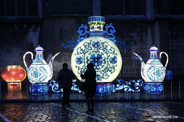 Tourists take photos of Chinese lanterns at an exhibition in Dinant, southern Belgium, on March 9, 2018. Two exhibitions dedicated to China: an exhibition of giant luminous lanterns and another exhibition of Chinese masks named 