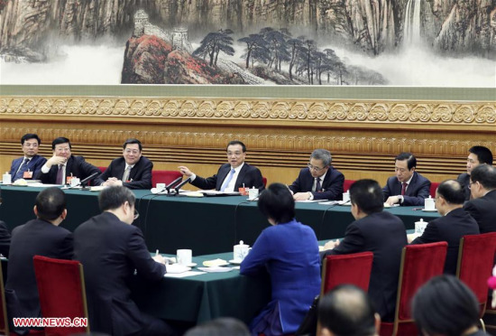 Chinese Premier Li Keqiang, who is also a member of the Standing Committee of the Political Bureau of the Communist Party of China (CPC) Central Committee, joins a panel discussion with the deputies from Hunan Province at the first session of the 13th National People's Congress in Beijing, capital of China, March 12, 2018. (Xinhua/Ding Lin)